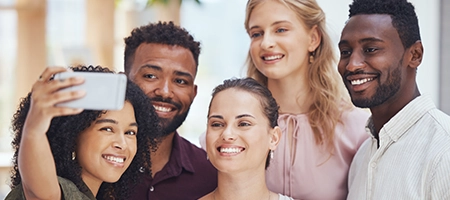 Group of friends crowding together for a selfie